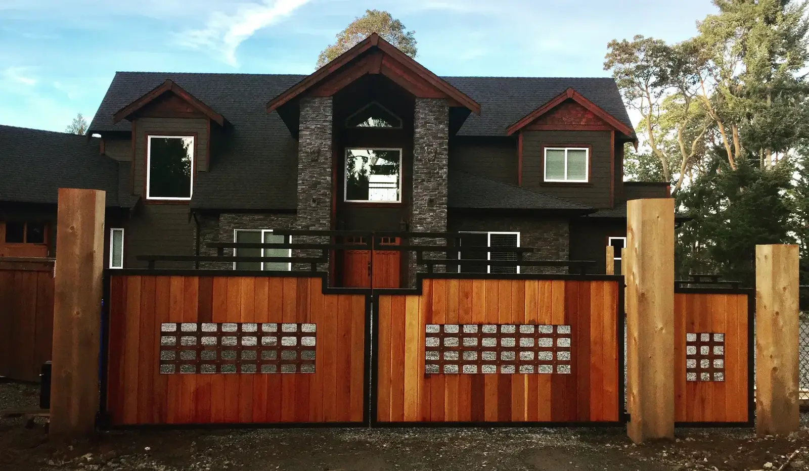 Cedar estate gates and fence across a wide driveway