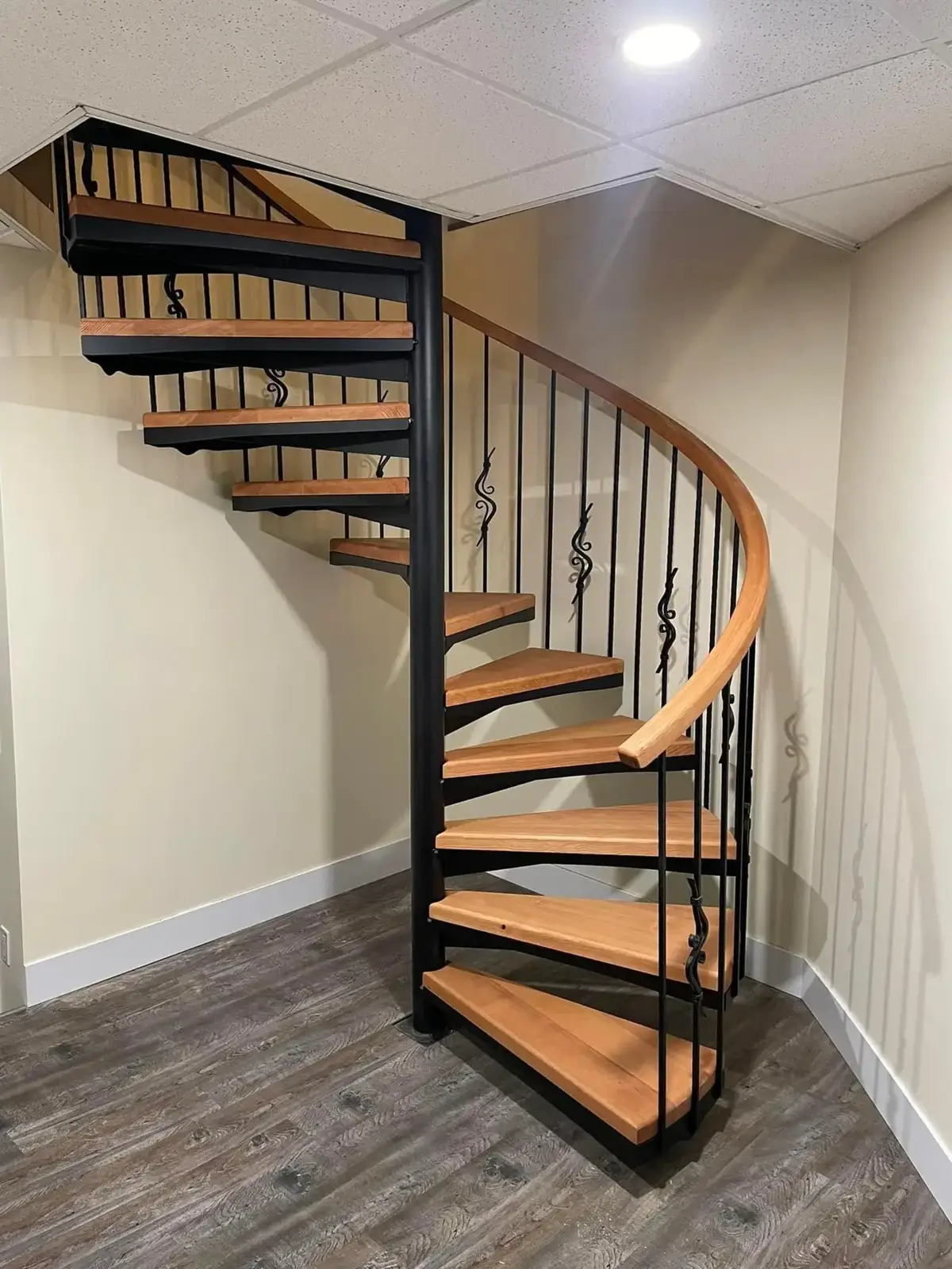 Interior spiral stair with wood treads and a curved rail