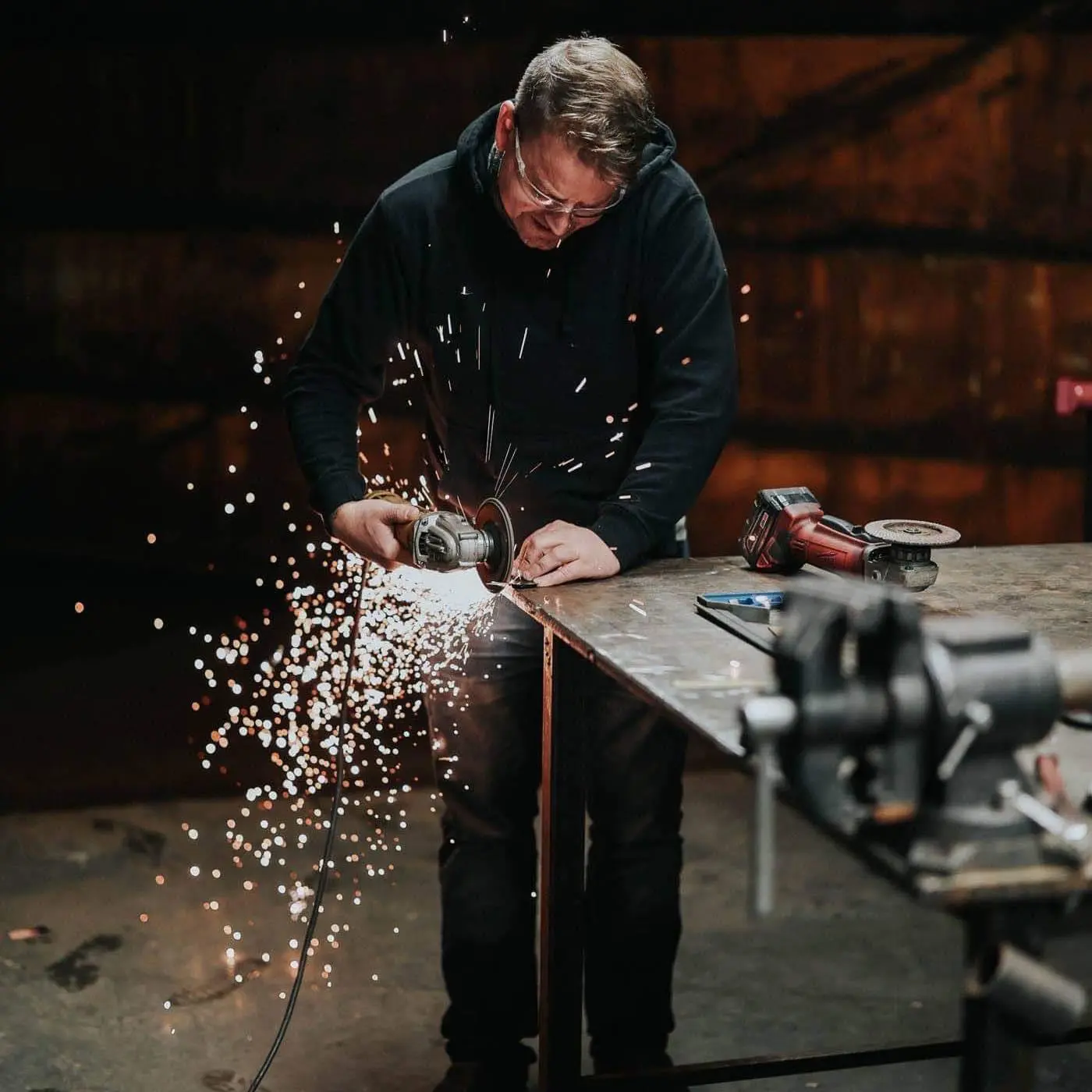Travis Rankin grinding steel in the shop